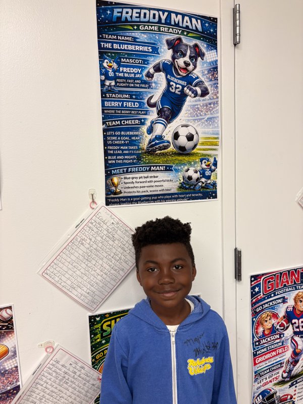 Dressed in blue, Mazeir Rogers matches the colors of his soccer-themed project.